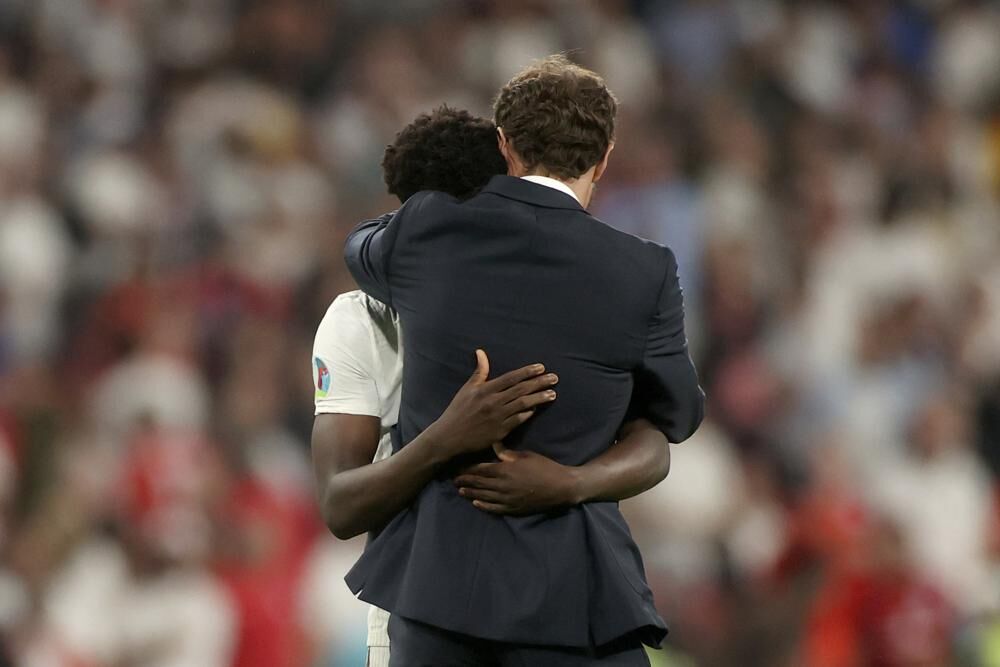 coach and saka hug